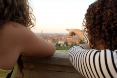 Students point out the iconic medieval tower of Bologna from a scenic viewpoint
